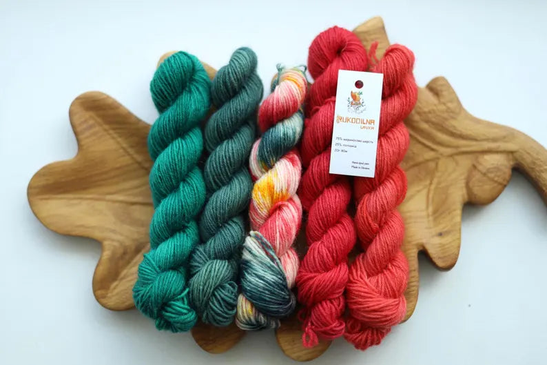 Christmas mini skein set with five hand dyed red green and multicolor fingering weight sock yarn minis
