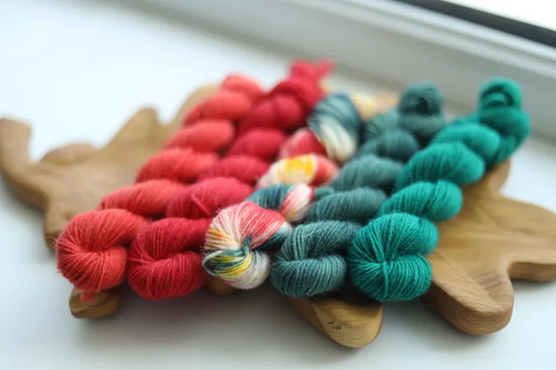 Christmas mini skein set with five hand dyed red green and multicolor fingering weight sock yarn minis