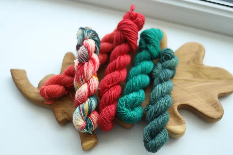 Christmas mini skein set with five hand dyed red green and multicolor fingering weight sock yarn minis