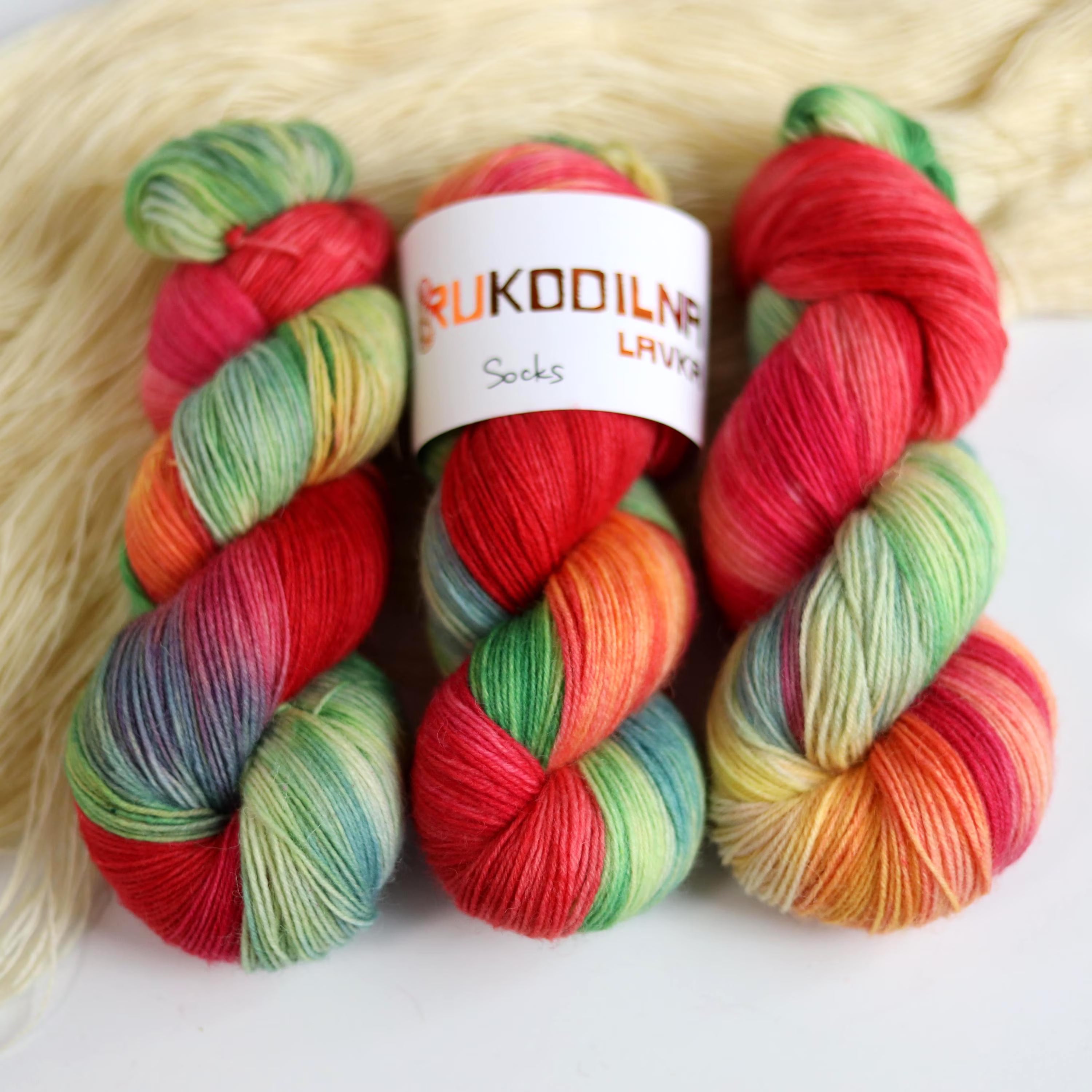 Bright hand dyed sock yarn in watermelon pink, lime green, aqua blue and sunset orange tones on superwash wool nylon fingering weight base.