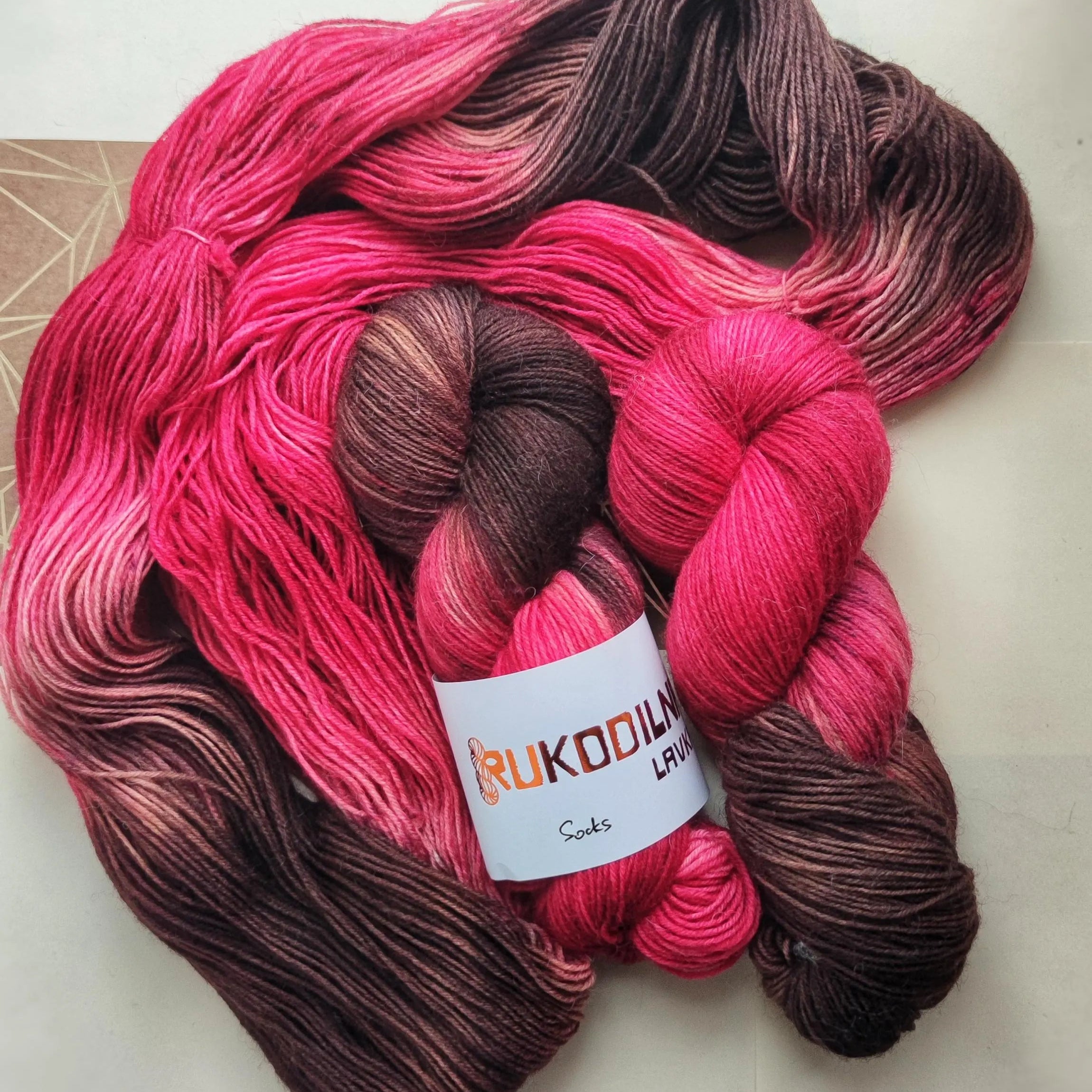 Hand dyed wool polyamide sock yarn in raspberry pink and deep chocolate brown shades inspired by berries and dark cocoa tones.