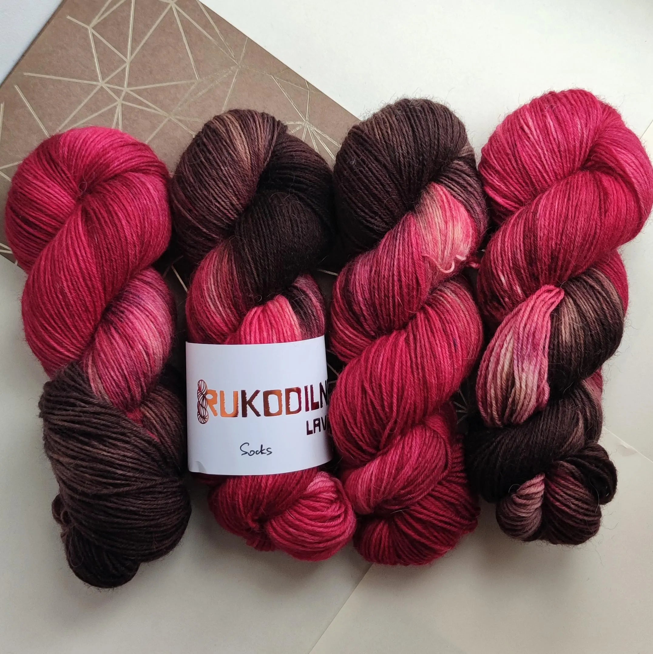 Hand dyed wool polyamide sock yarn in raspberry pink and deep chocolate brown shades inspired by berries and dark cocoa tones.