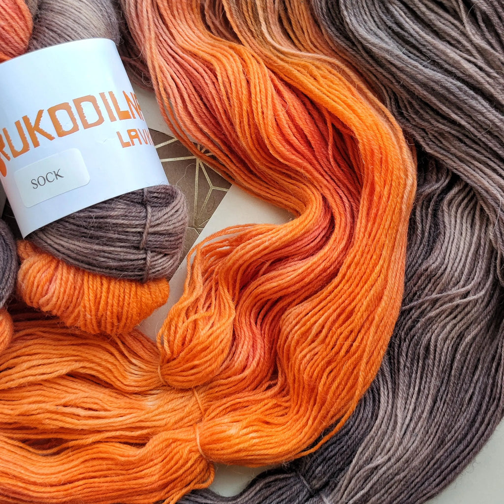 Hand dyed variegated sock yarn in smoky grey, charcoal, coral and bright orange shades, superwash wool nylon fingering weight 4 ply yarn for knitting socks shawls and sweaters