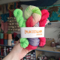 Hand dyed yarn set with one full skein and two mini skeins in bright pink, purple and green shades inspired by blooming lupine flowers.